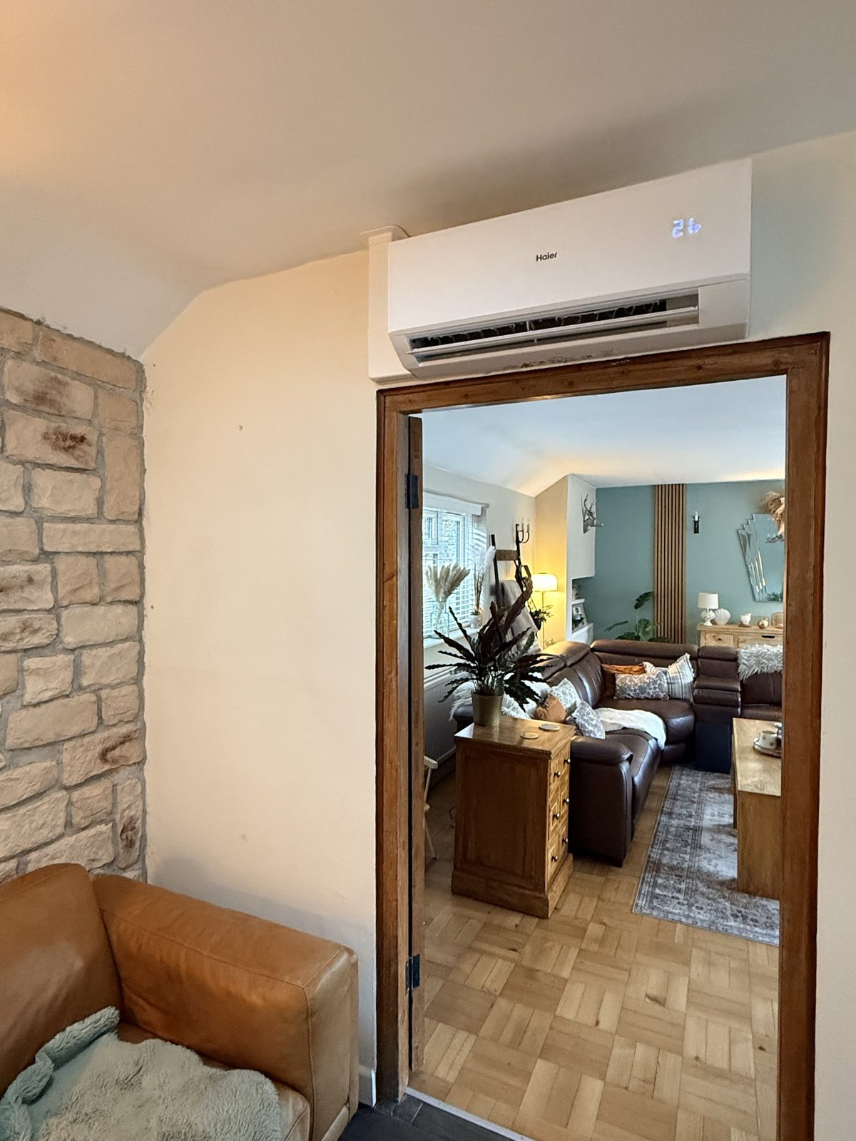 Haier indoor air conditioning unit mounted above a wooden door frame