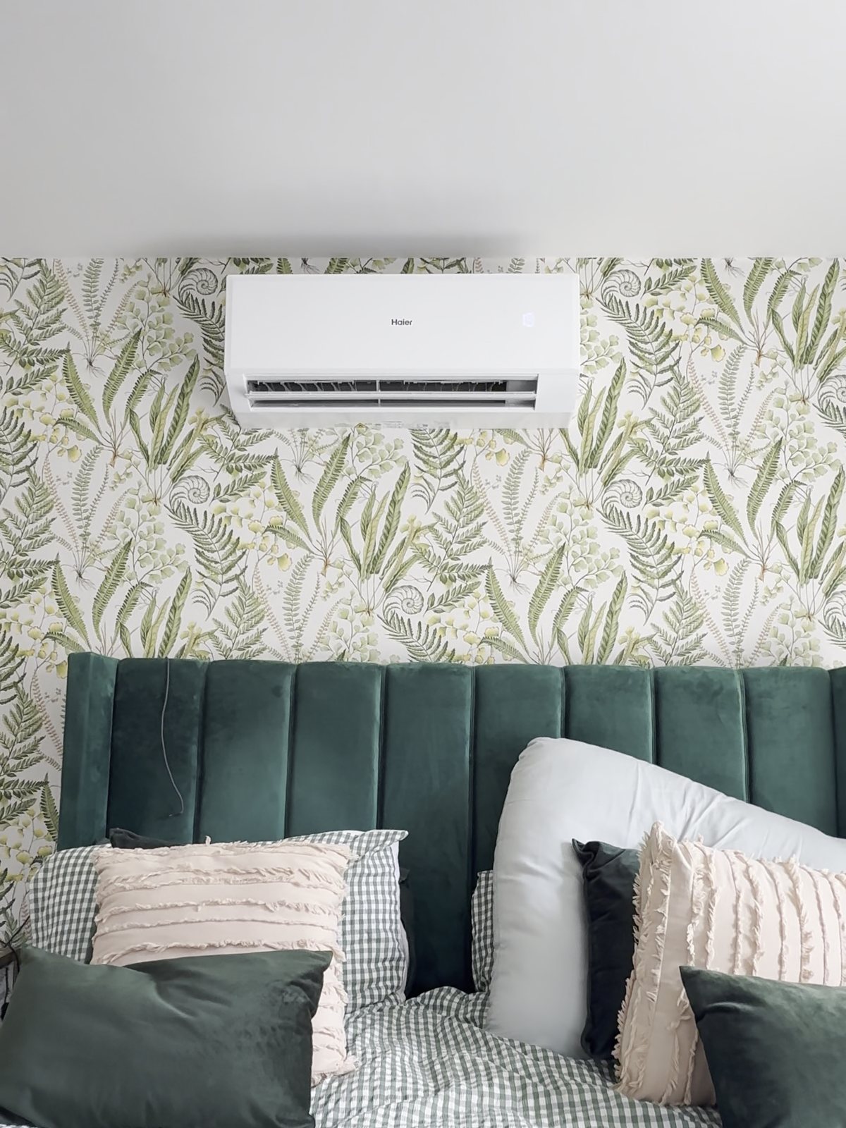 Haier wall-mounted air conditioning unit above a bed in a Bicester bedroom